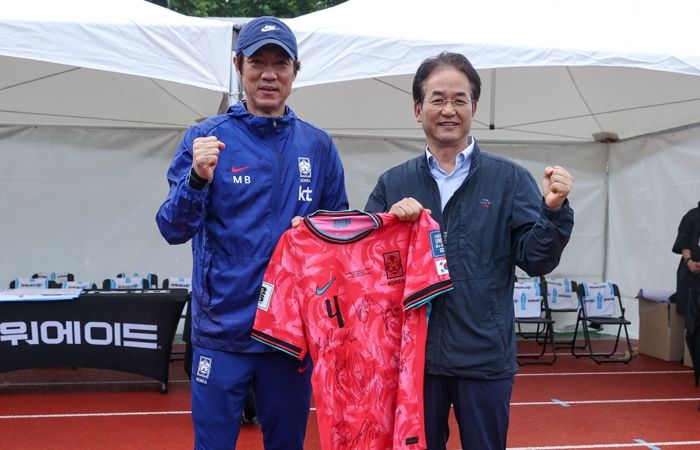 1. 국가대표팀 선수들의 친필 사인 유니폼을 들고 기념촬영 중인 이동환 고양특례시장(오른쪽)과 홍명보 축구 국가대표팀 감독(왼쪽)